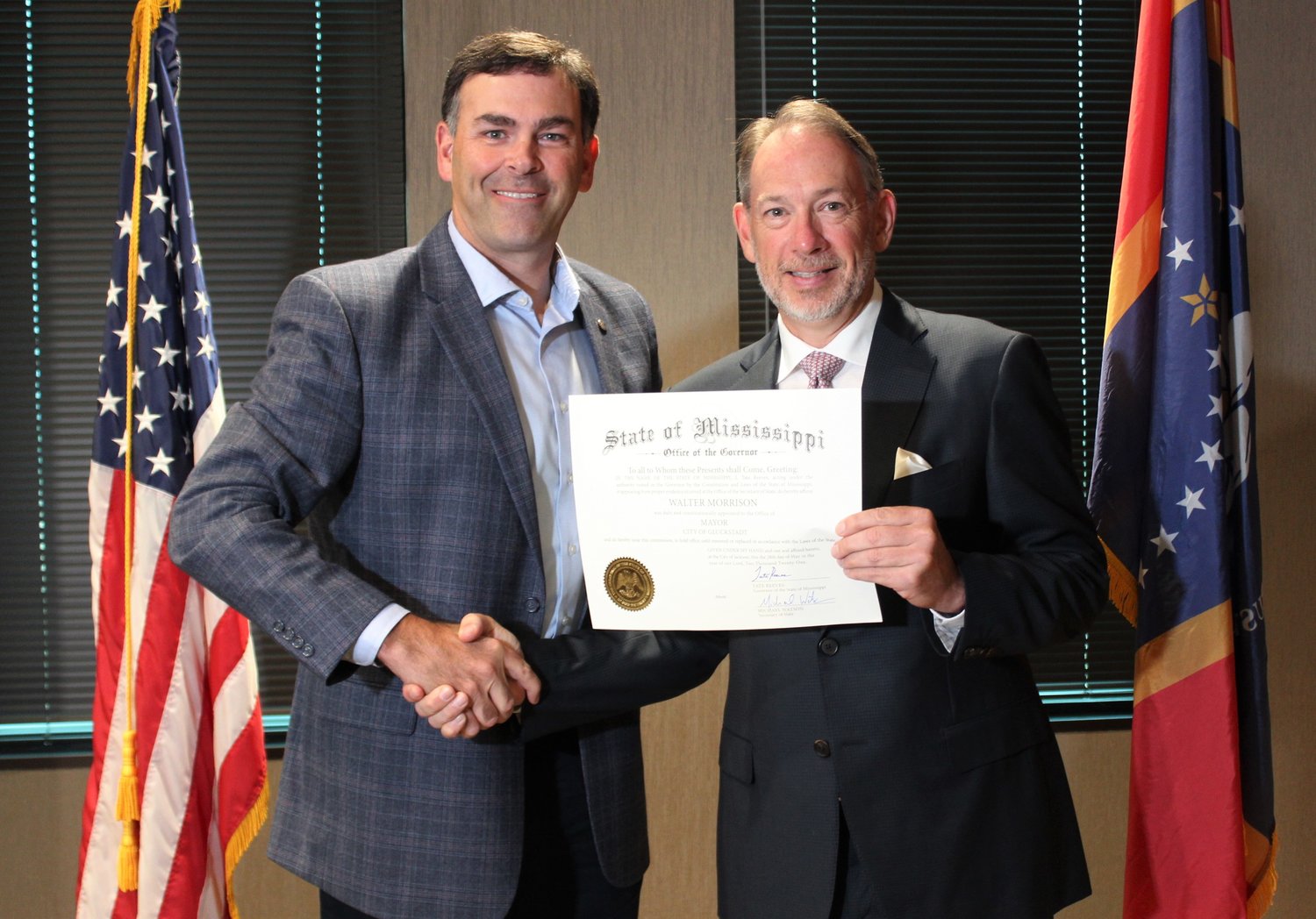 Secretary of State Michael Watson a commission to Gluckstadt Mayor Walter Morrison during the commissioning of newly appointed Gluckstadt government officials last week in Jackson.